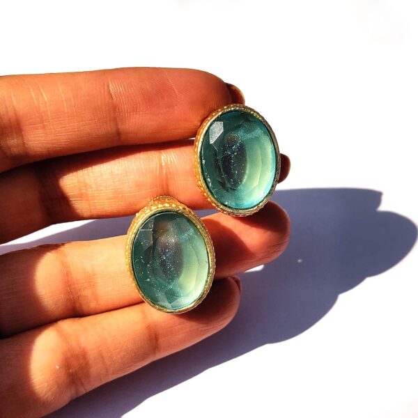 Ocean Blue Topaz Goldplated Studs with Detailed Bezel Hand