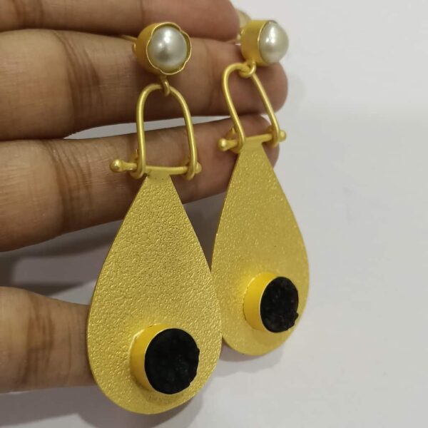 Golden Swing Dangler Black and White Earrings Hand 1