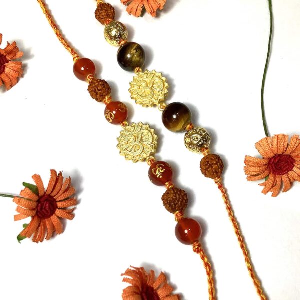 Orange Onyx and Tigers Eye Gold plated OM Rakhi Combo set Image